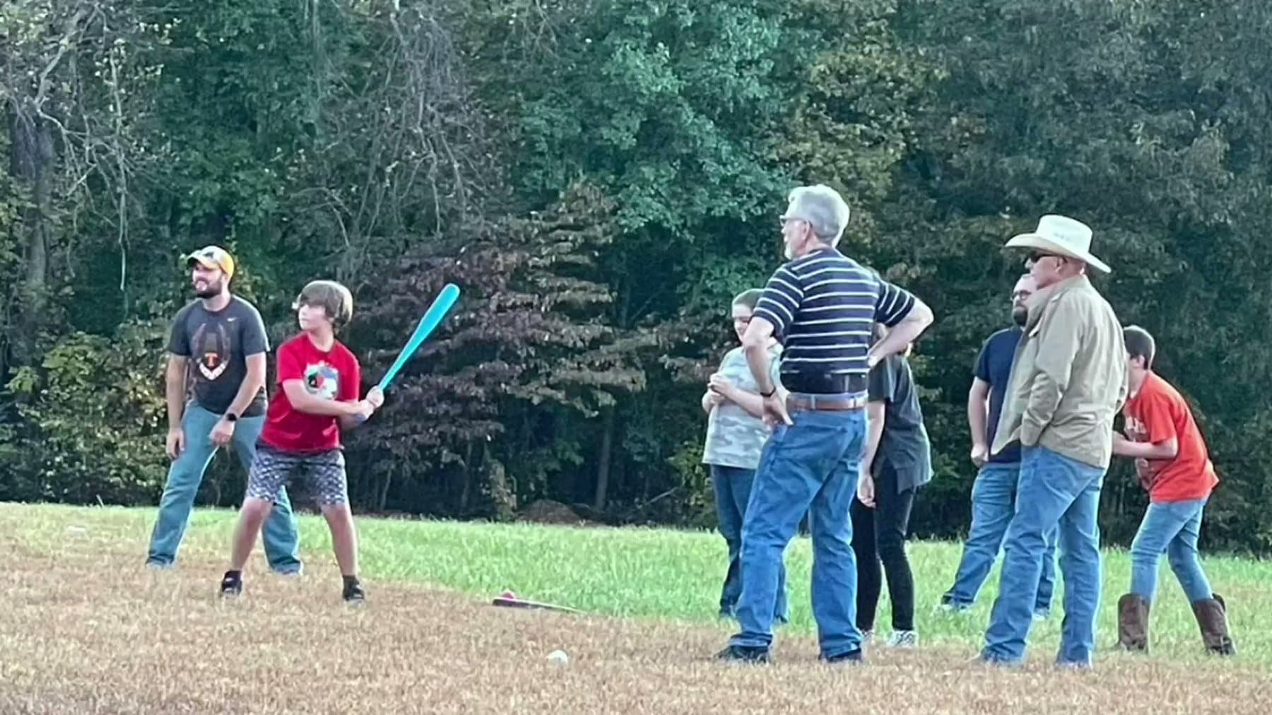 Church families gathered on the field at 610 Myers Lane on a summer evening