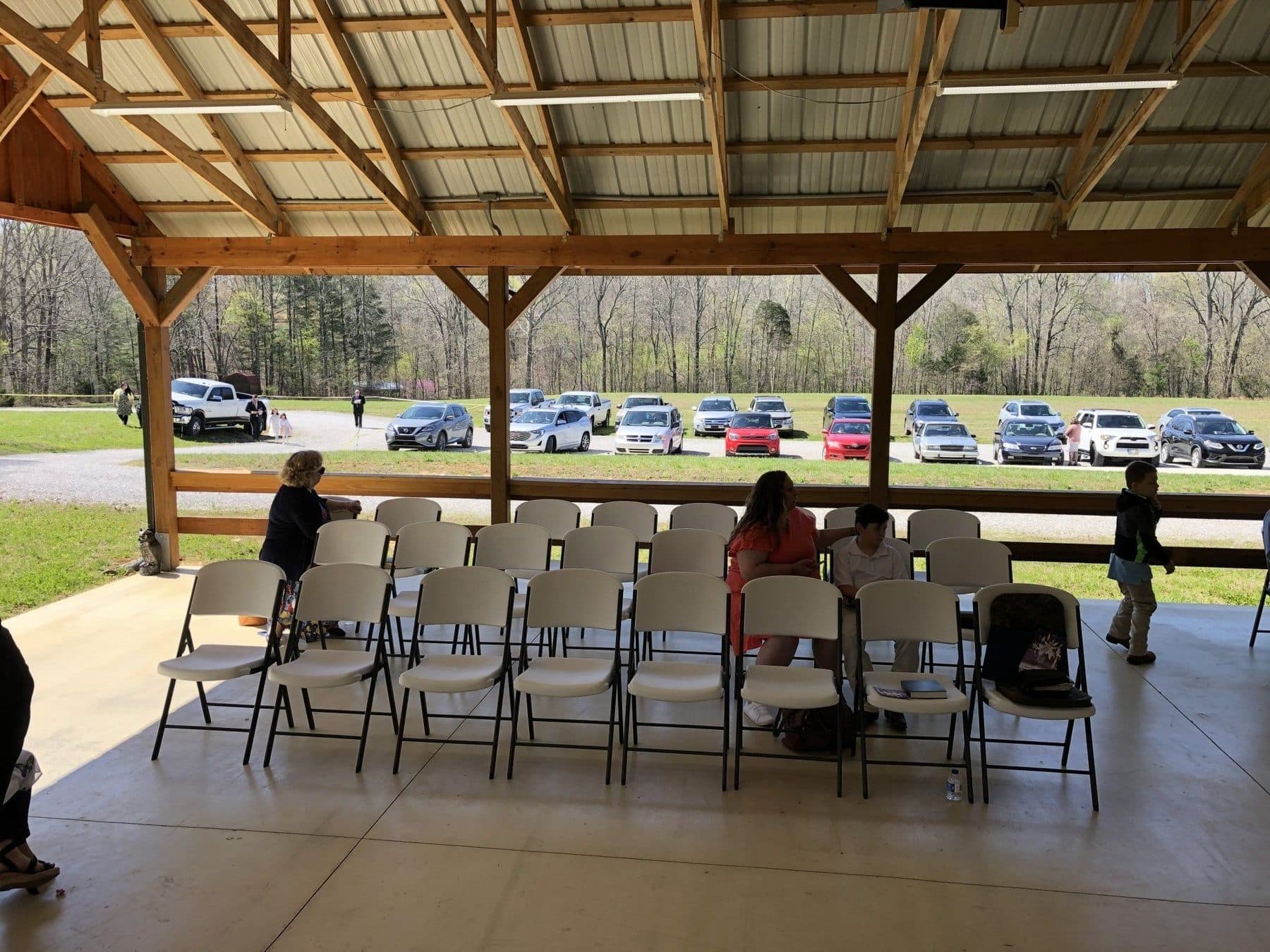 Cars parked along the drive at 610 Myers Lane during a service